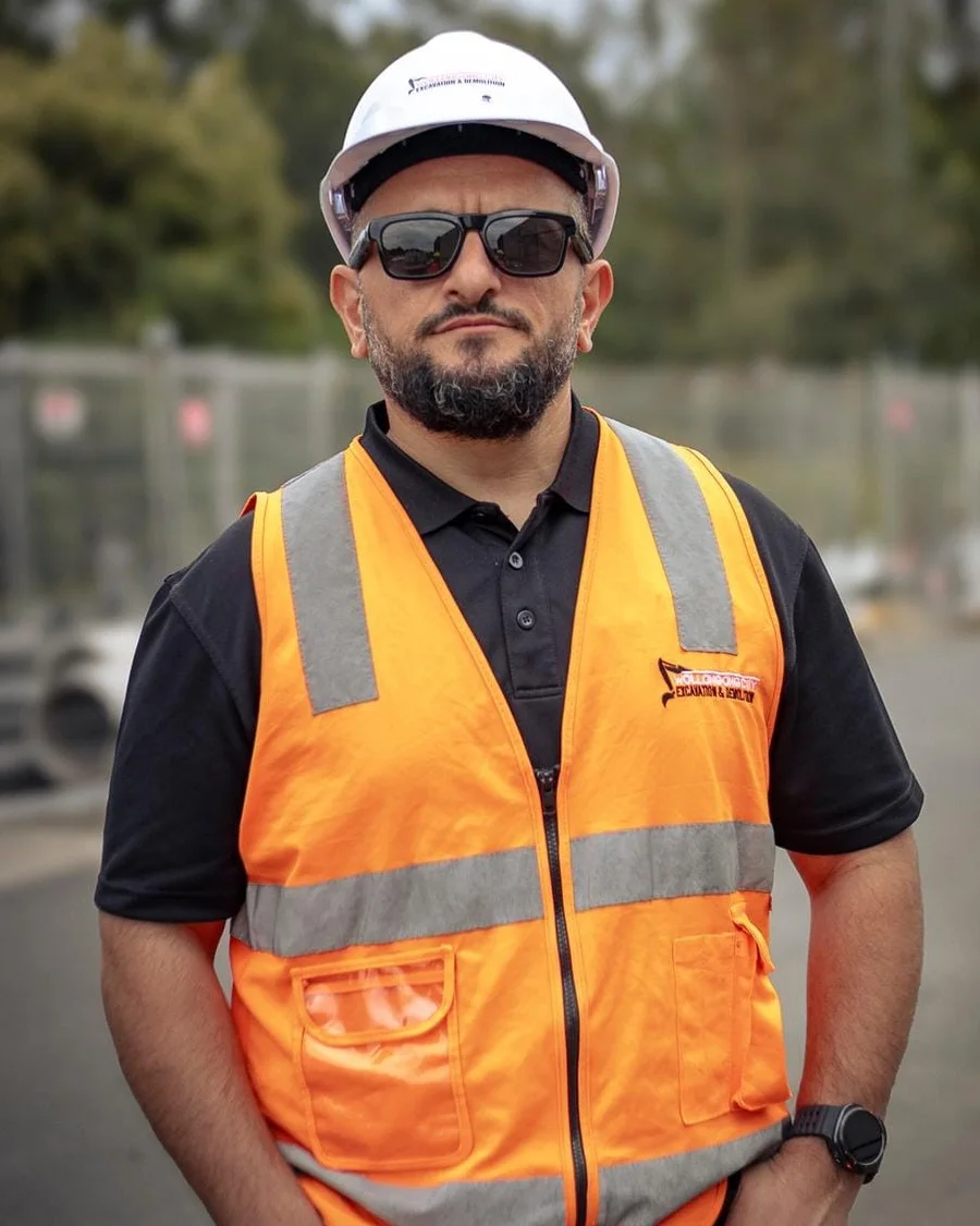 Naeem, Founder & Managing Director of WCED, on site in hi-vis and hard hat